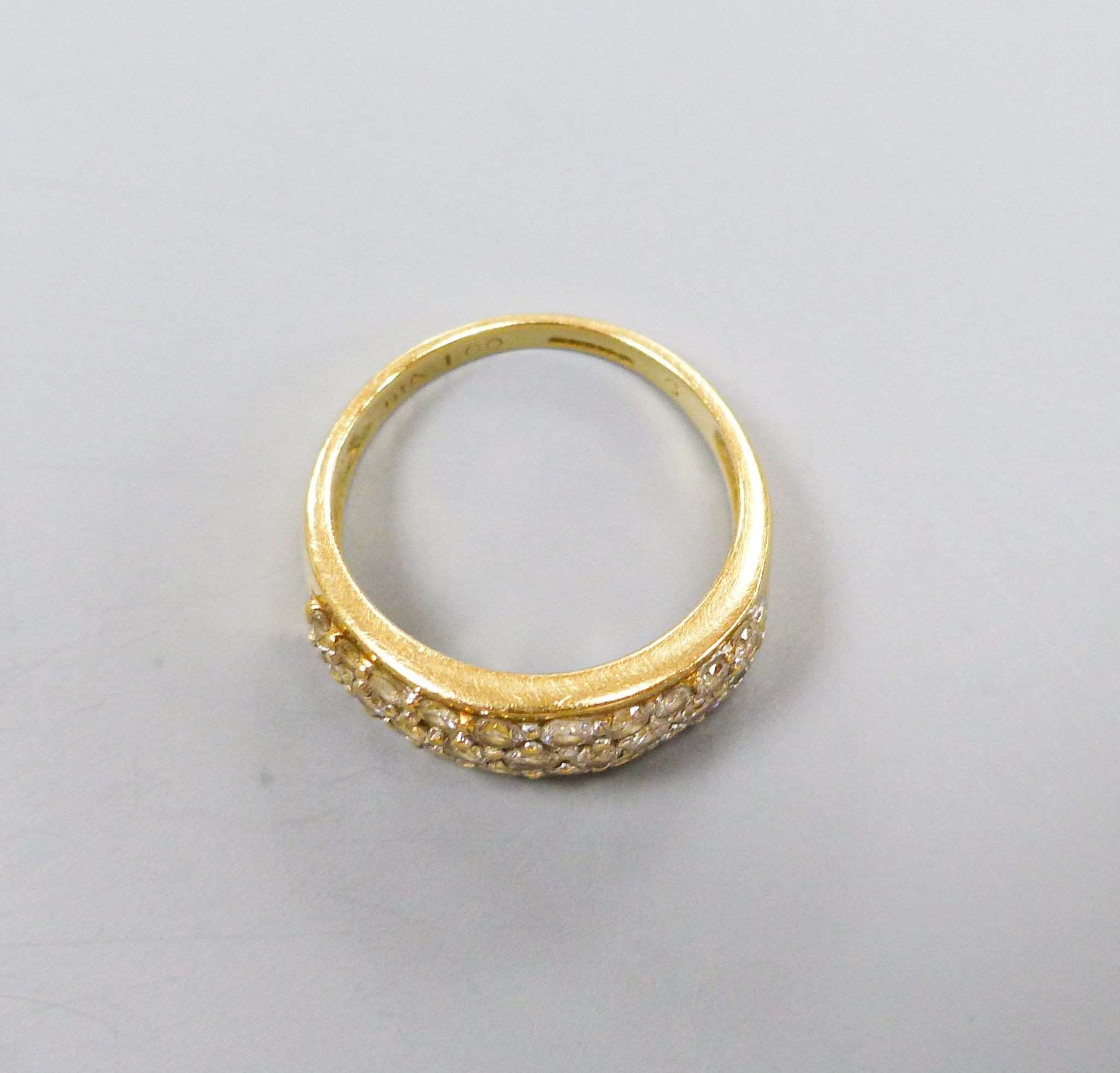 A modern 18ct gold and diamond encrusted half hoop ring, total diamond weight approx. 1.00ct, size N, gross 5.4 grams.